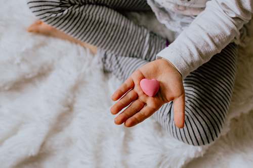 human child holding heart stone person