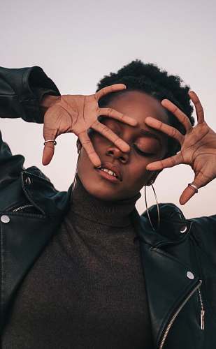 finger closed eyed woman covering her face with her hands face