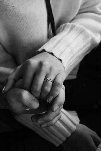 black-and-white grayscale photo of person wearing ring grey