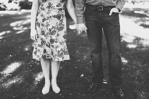 black-and-white grayscale photography of man and woman holding hands grey