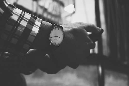 black-and-white grayscale photography of man wearing analog watch grey