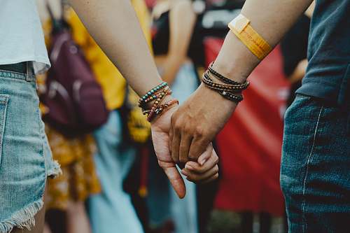 human man and woman holding hands near people person