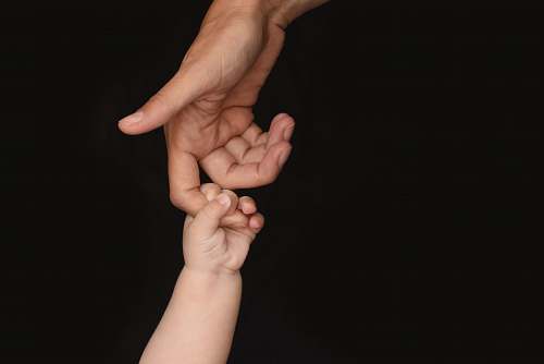 human person and baby holding hands person