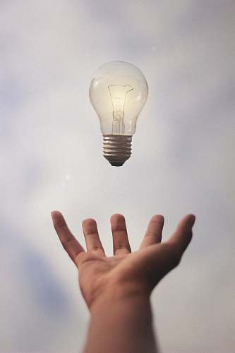 light person catching light bulb lightbulb