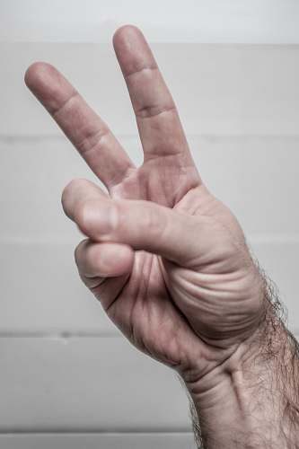 finger person doing hand peace symbol person