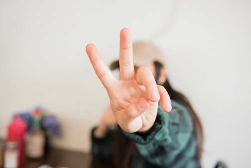 person person doing peace sign finger