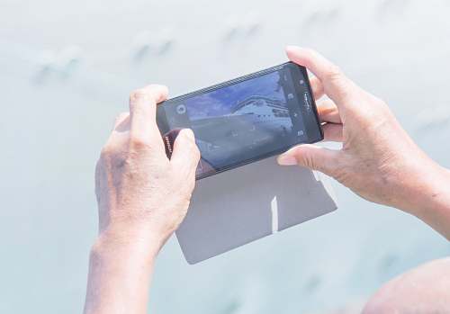 phone person holding Android smartphone overseas passenger terminal
