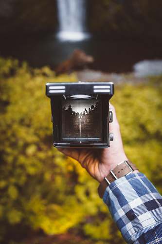 holding person holding black frame multnomah falls