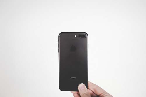 grey person holding black iPhone 7 Plus cell phone
