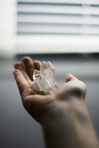 crystal person holding crystal stones cologne