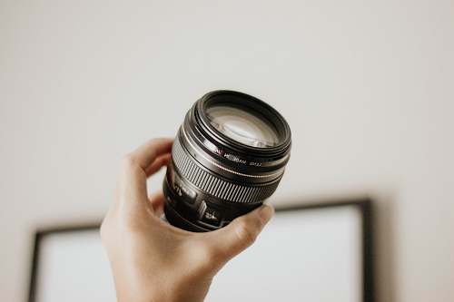 lens person holding DSLR camera lens glass