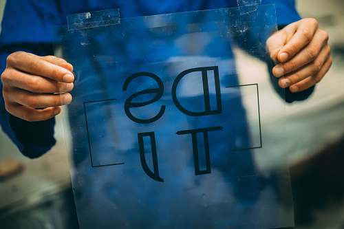 human person holding DSTI plastic frame finger