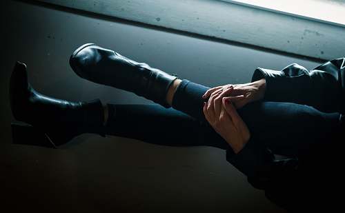 arm person holding its knees close-up photography apparel