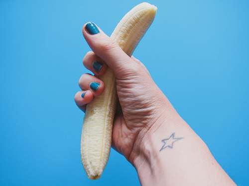 masturbation person holding peeled banana fruit sex ed