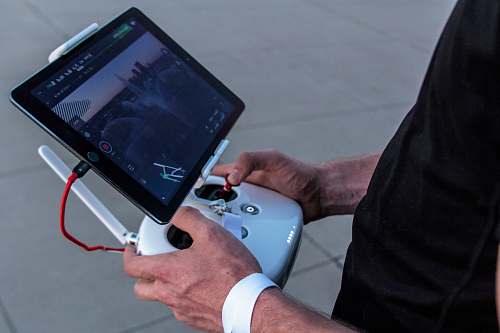 drone person holding quadcopter controller tablet