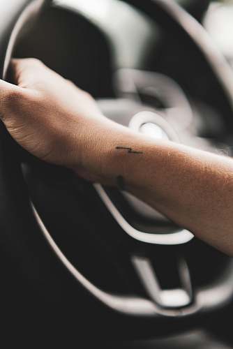 skin person holding steering wheel wrist