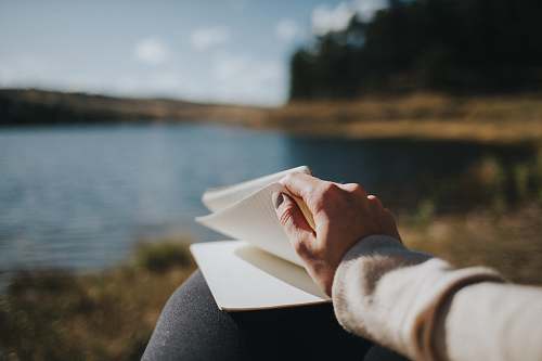 human person holding white book person