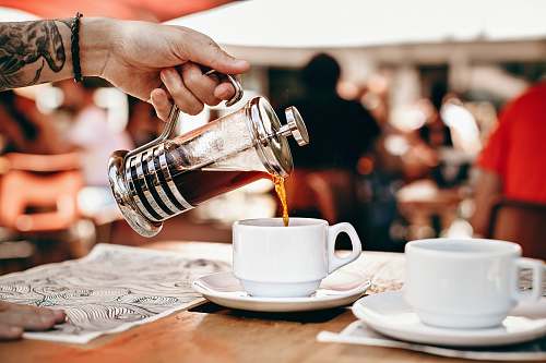cup person pouring tea on white teacup coffee cup