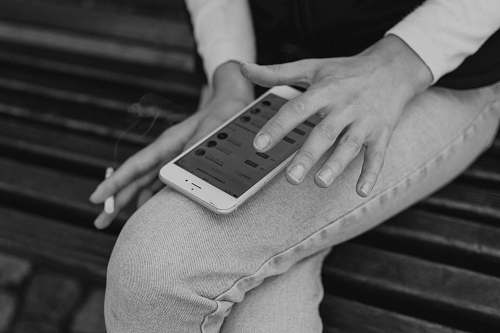 black-and-white person using phone grey