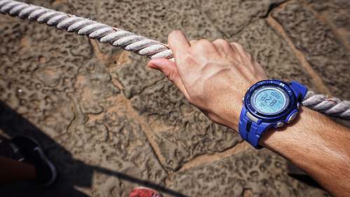wrist person wearing blue digital watch with strap wristwatch