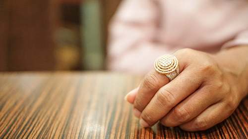 human person wearing gold-colored ring person