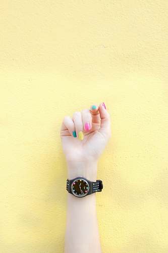 wristwatch person wearing round black analog watch at 9:46 nail