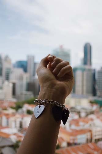 human person wearing silver-colored bracelet person