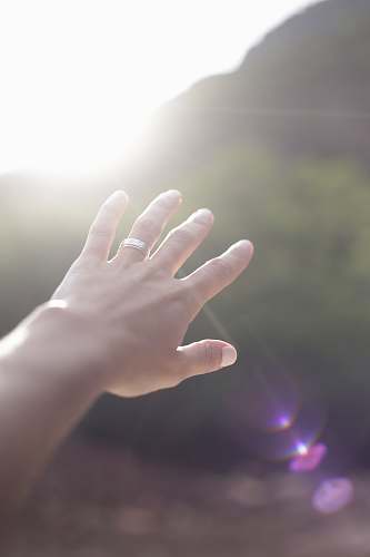 flare person wearing silver-colored wedding band light