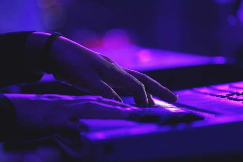 music person's hand on laptop piano
