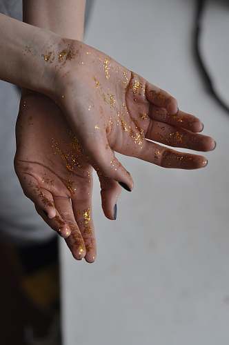 person person's hand with glitters finger