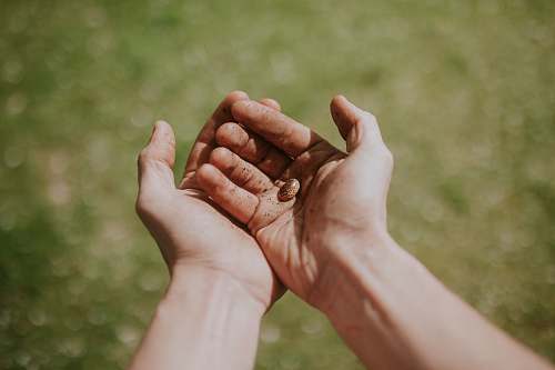 human person's left hand over right hand person