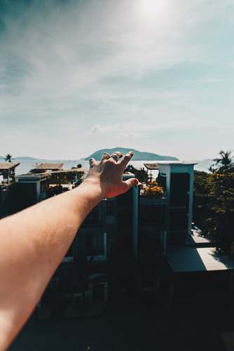 arm selective focus of person raising hand during daytime phuket