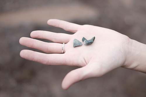 person three gray pebbles on person's palm human