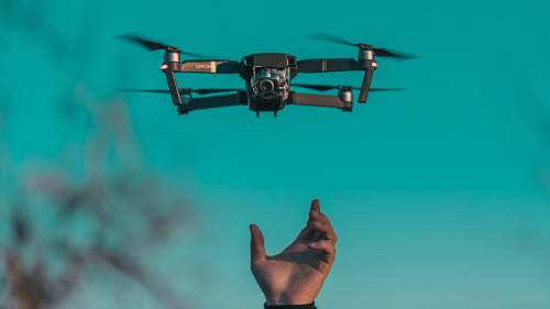 flying tilt shift lens photo of mini drone camera