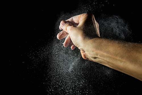 animal time lapse photography of person's hand with powder pet