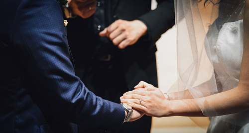 apparel woman holding man's hand during wedding ceremony clothing