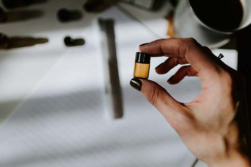 person woman holds small oil bottle human