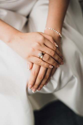 wedding woman wearing gold-colored and silver-colored rings ring