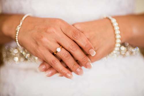 human woman wearing gold-colored engagement ring person