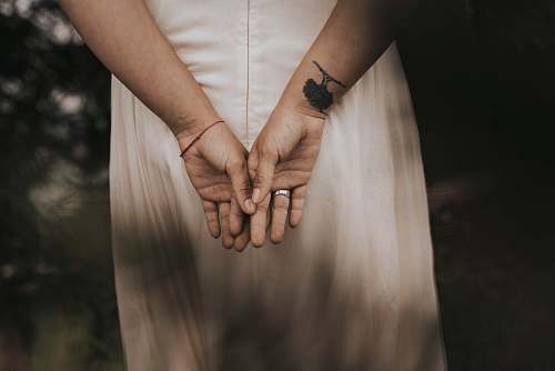 human woman wearing silver-colored ring holding hands