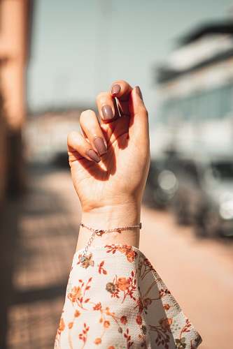 finger women's white and orange floral shirt person