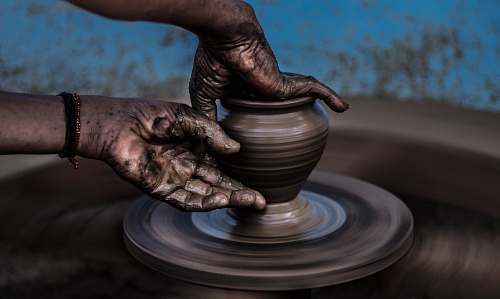 craft person molding vase art