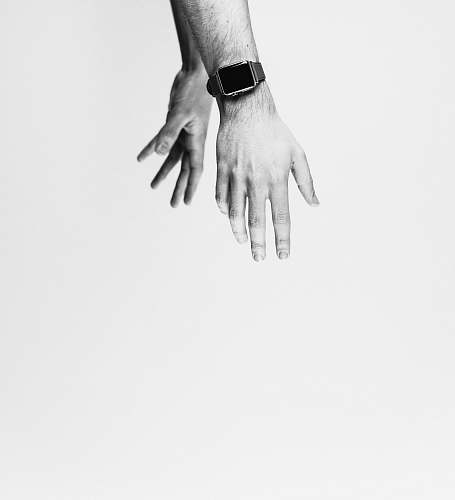 black-and-white person showing silver smartwatch minimal