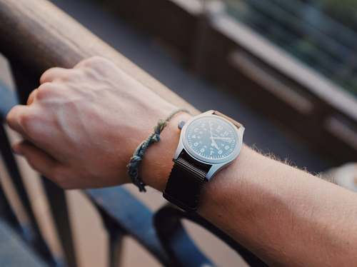 person analog watch displaying 7:51 time wristwatch
