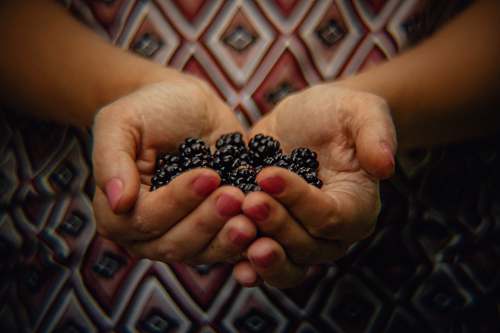 person black berries finger