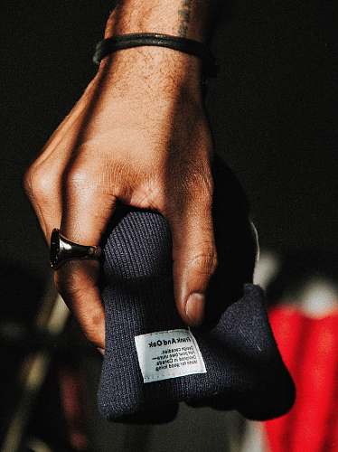 person black knit cap hand