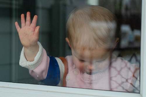 person child behind clear glass finger