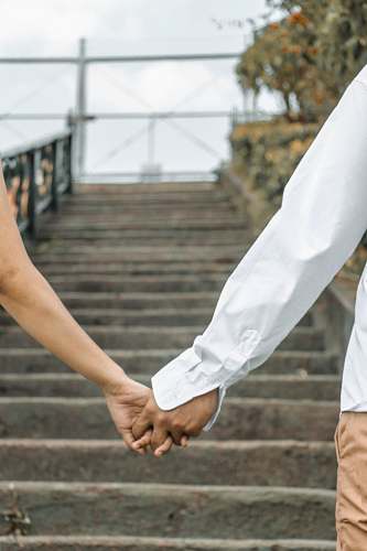 apparel couple holding hand by the stairs outdoors clothing