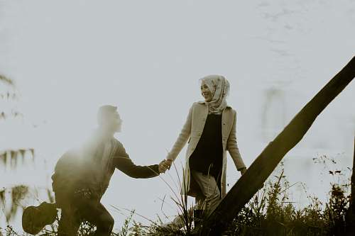 person couple holding hands during daytime hand