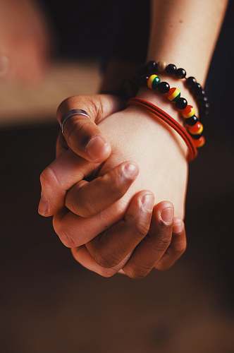person couple holding hands while wearing ring and bangle hand